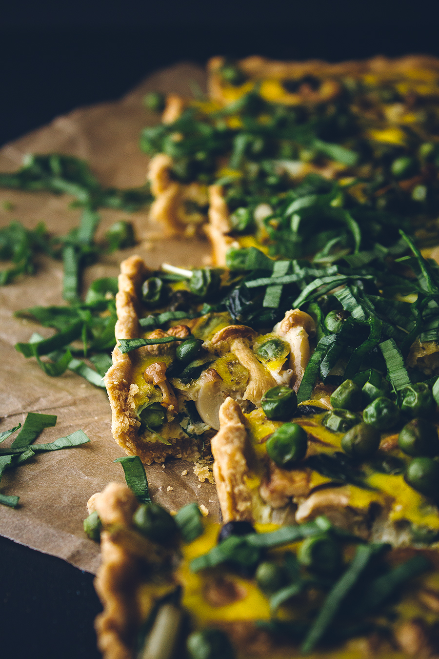 loaded veggie quiche on brown towel