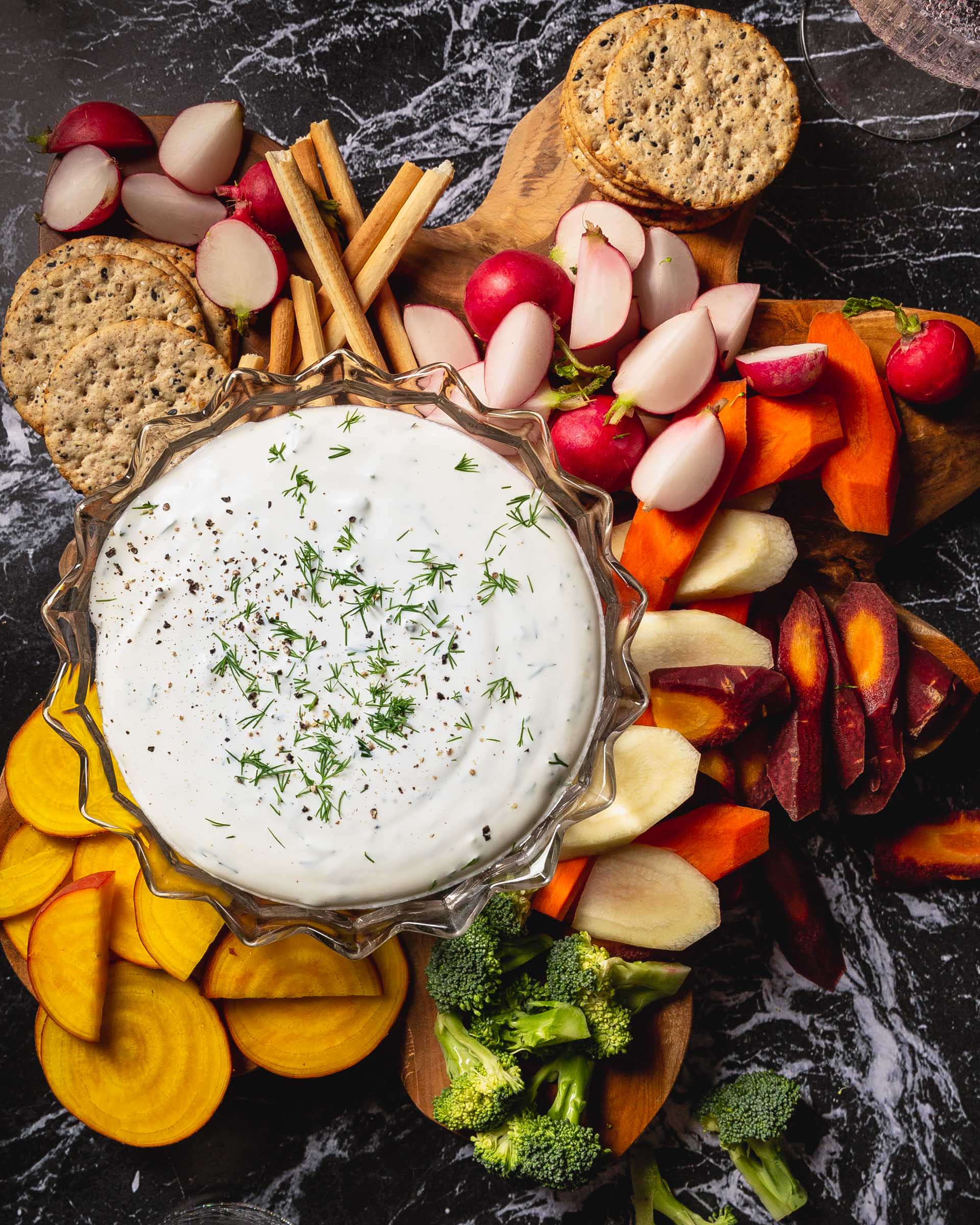 buttermilk dip in bowl with veggies and crackers around it