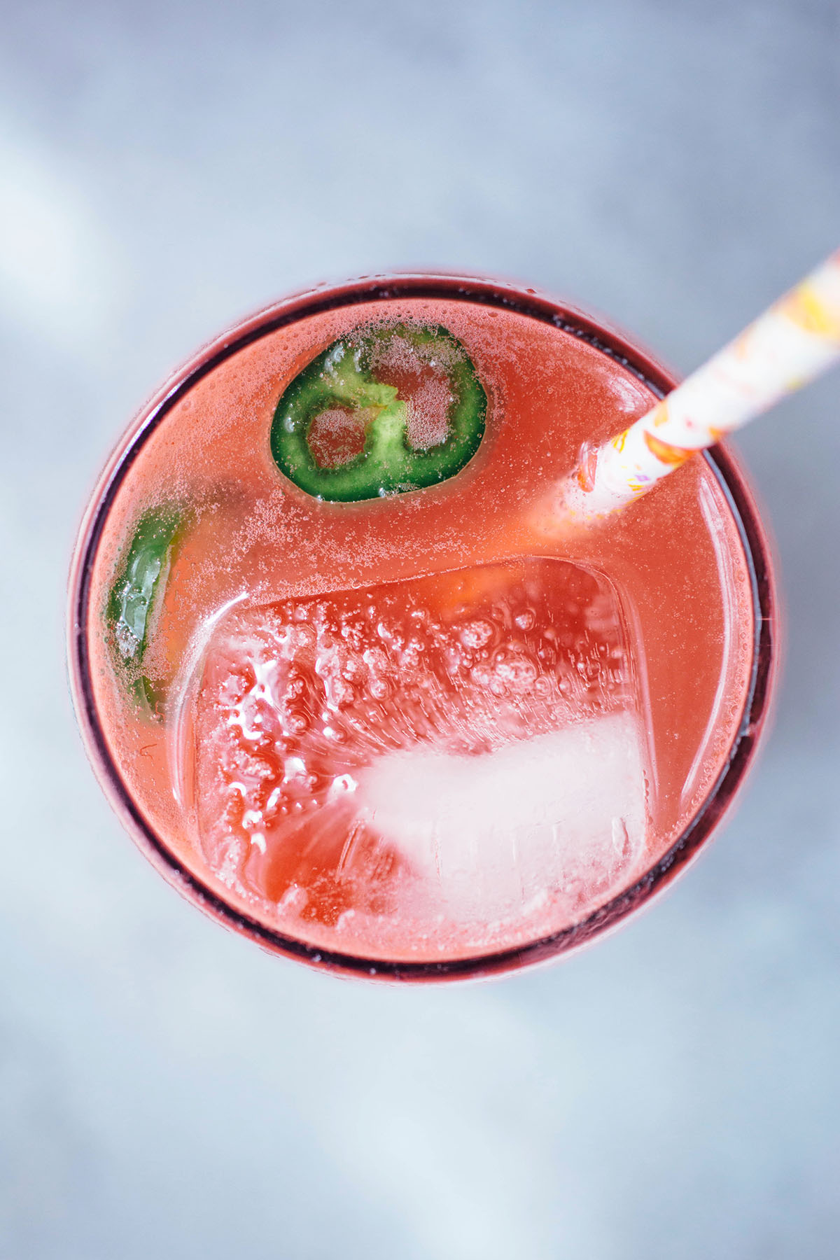 Spicy Watermelon Soda garnished with jalapeno slices and straw
