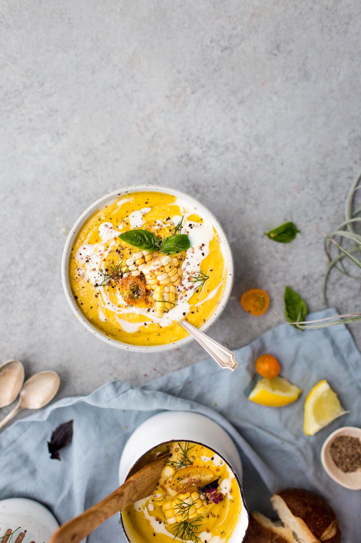 sweet corn and tomato gazpacho in white bowl and pitcher