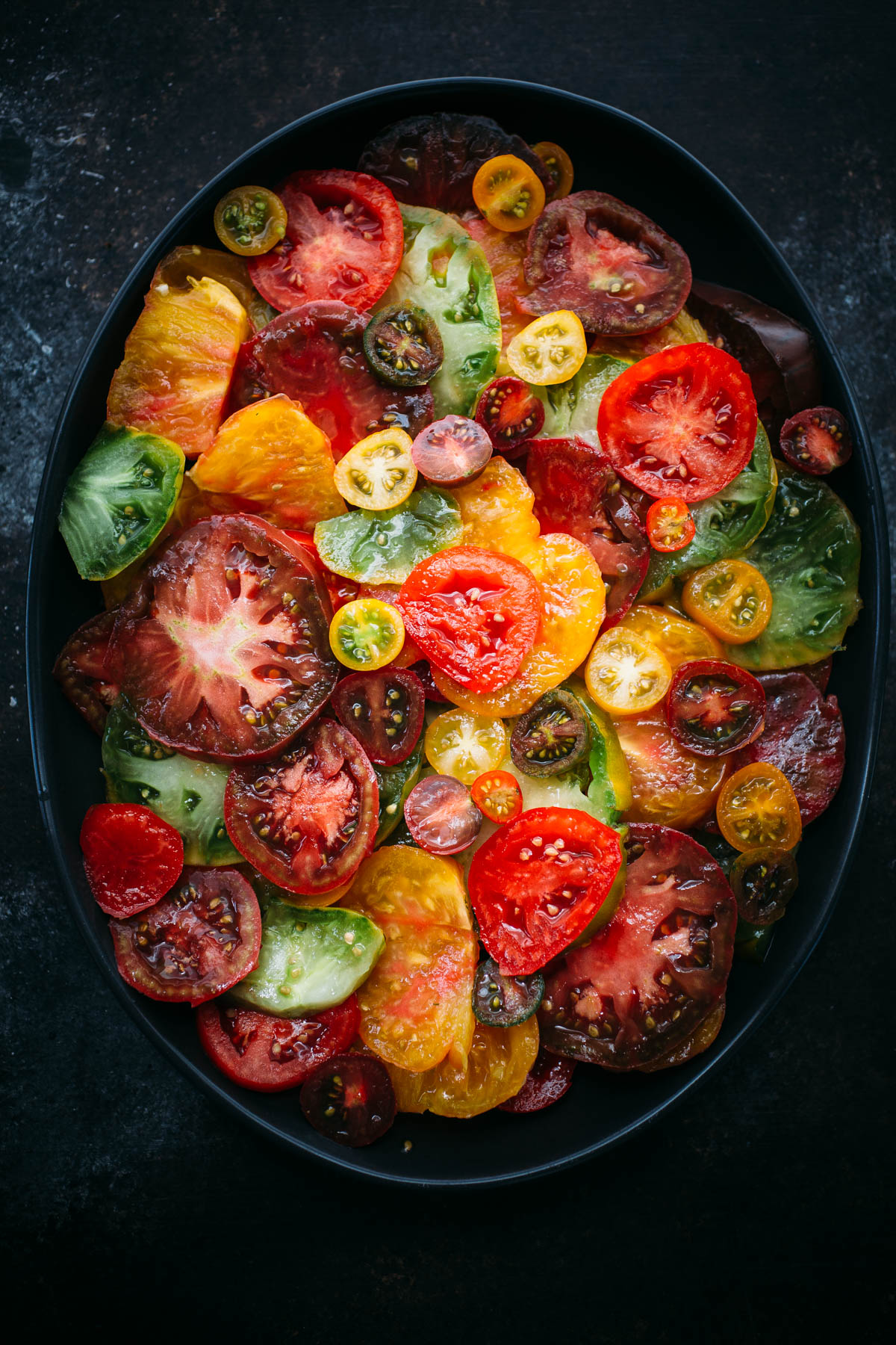 sliced heirloom tomatoes in large serving platter 