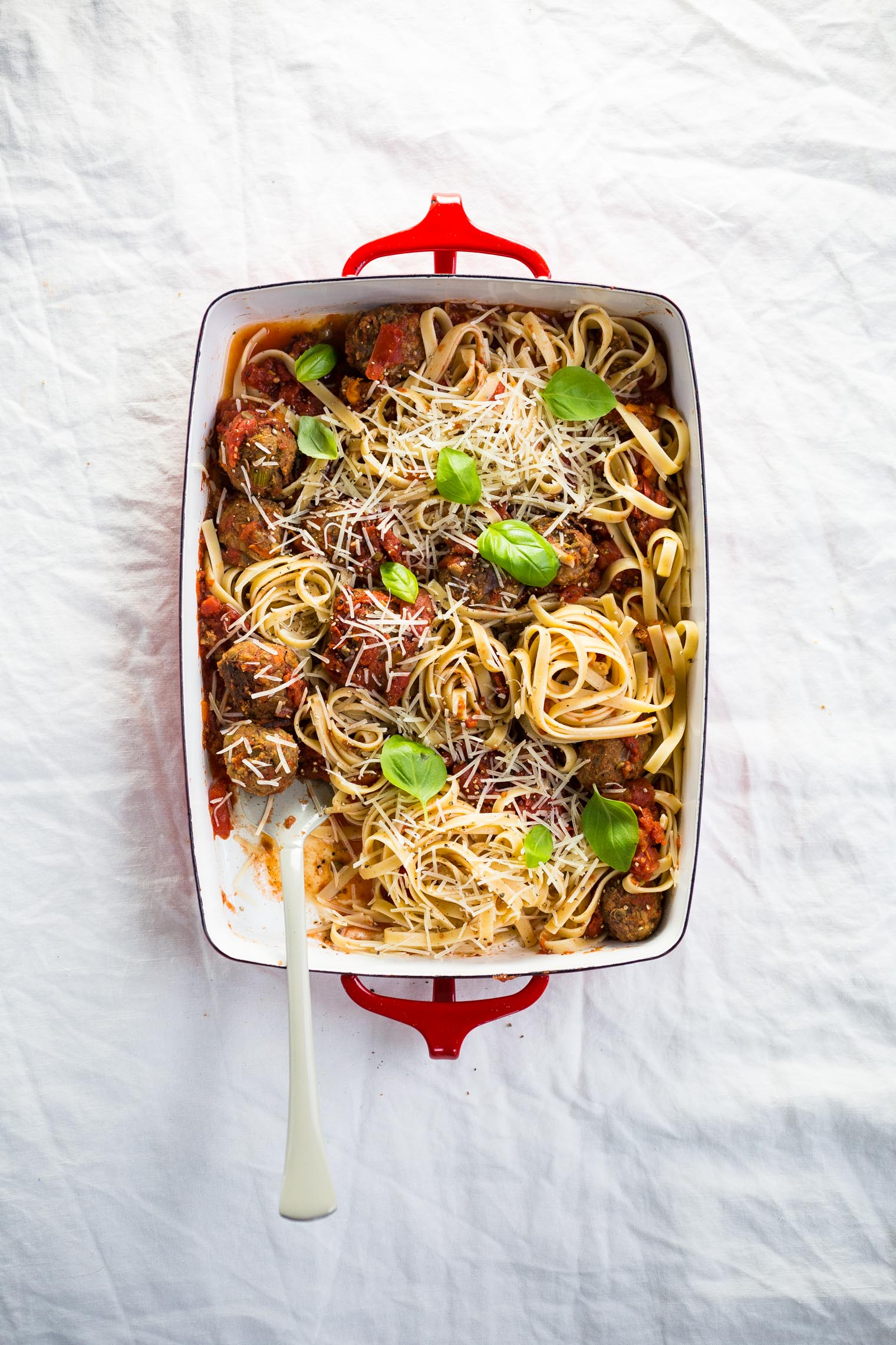 vegetarian meatballs, pasta, and sauce in baking dish 