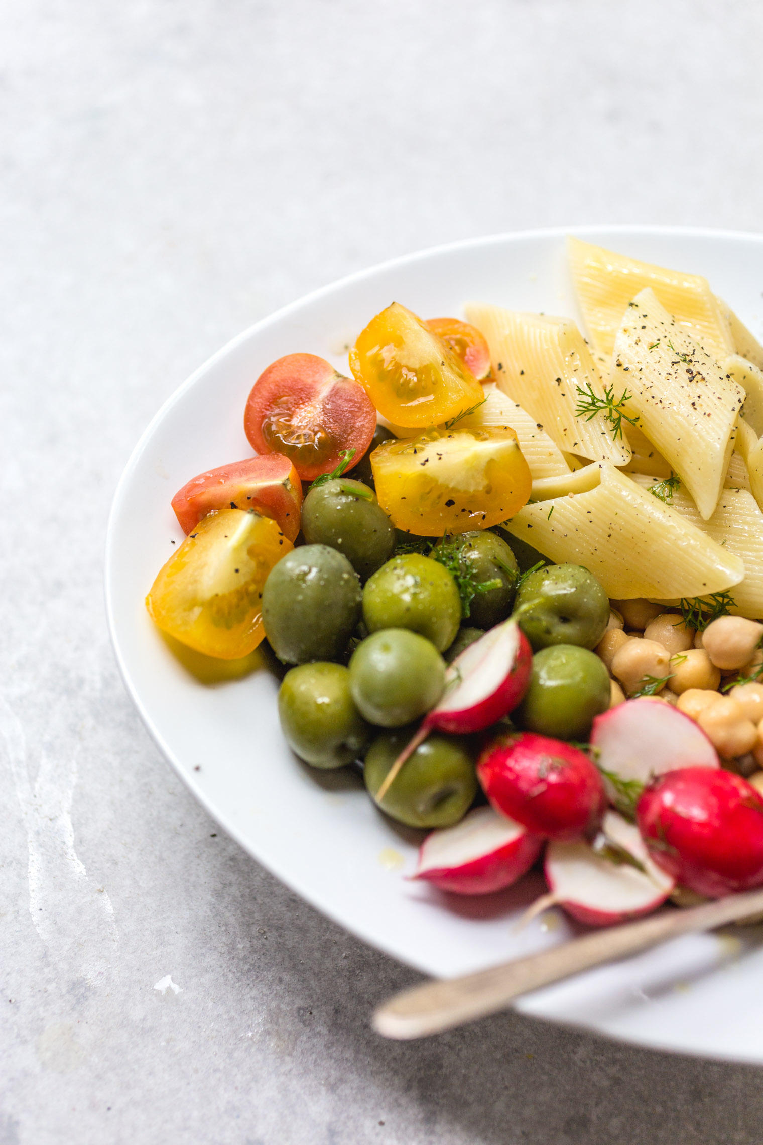 summer pasta salad on white platter