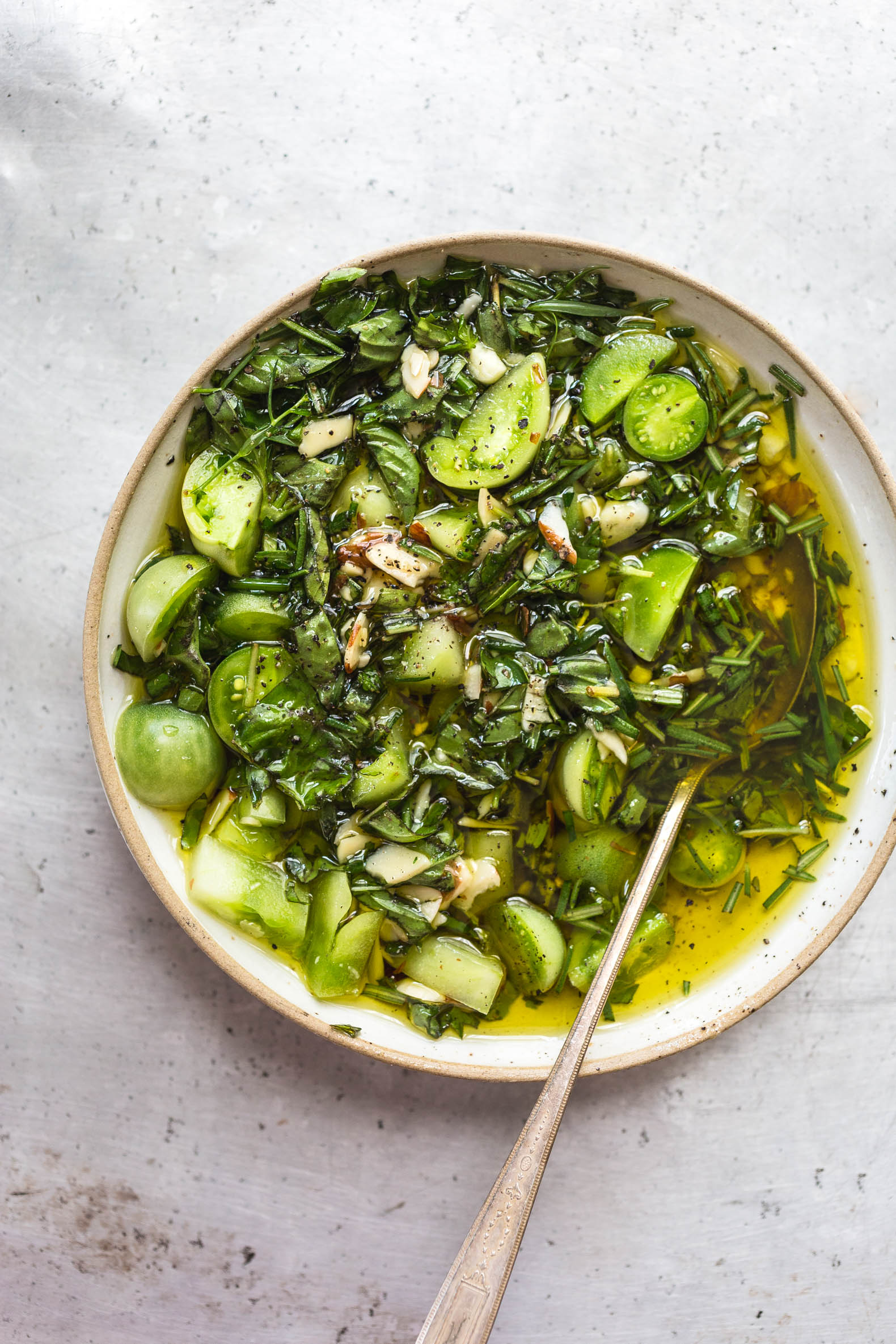 overhead view of green tomato salsa swimming in olive oil 