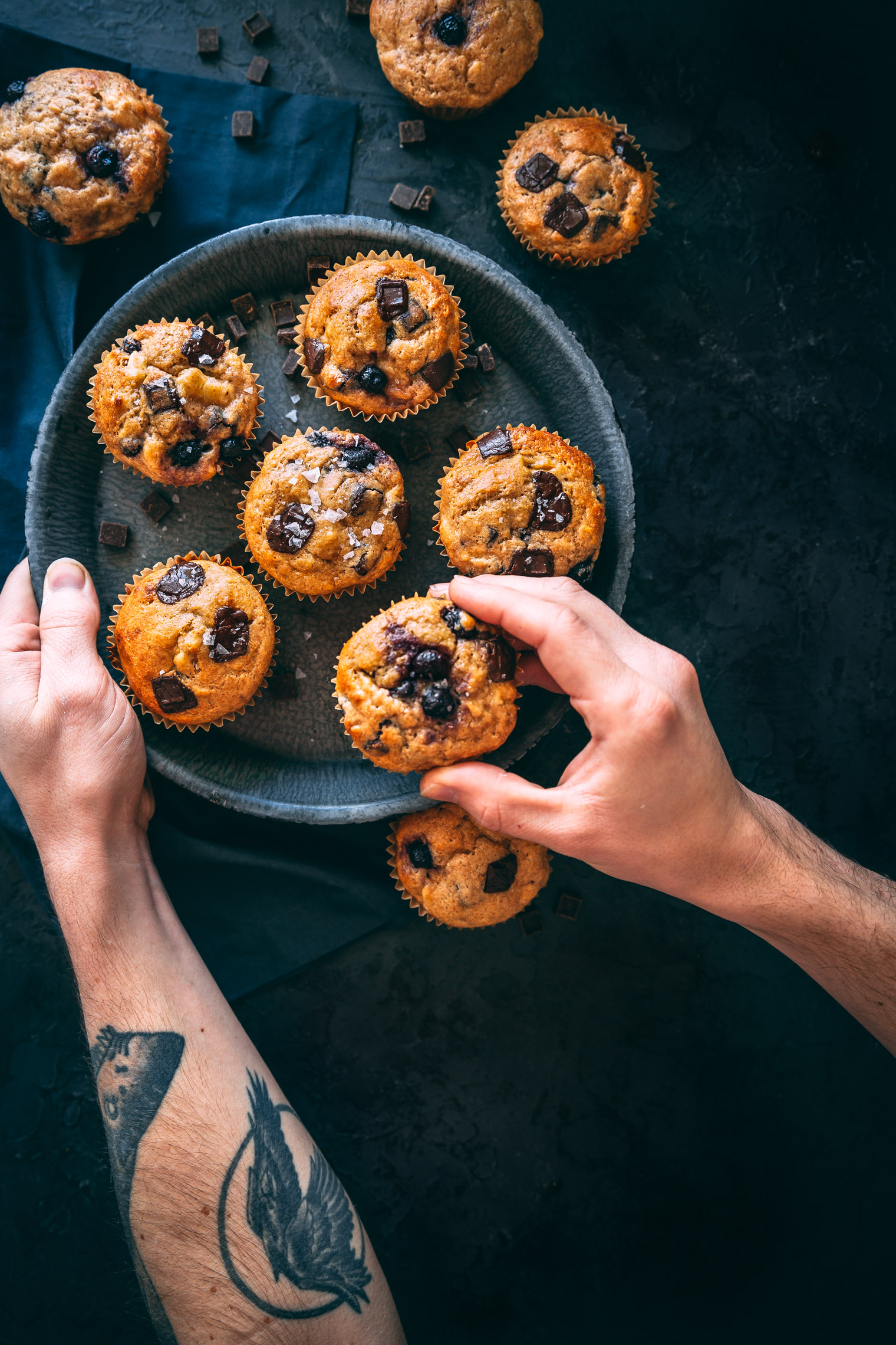 banana blueberry chocolate chip muffins on dark plate 