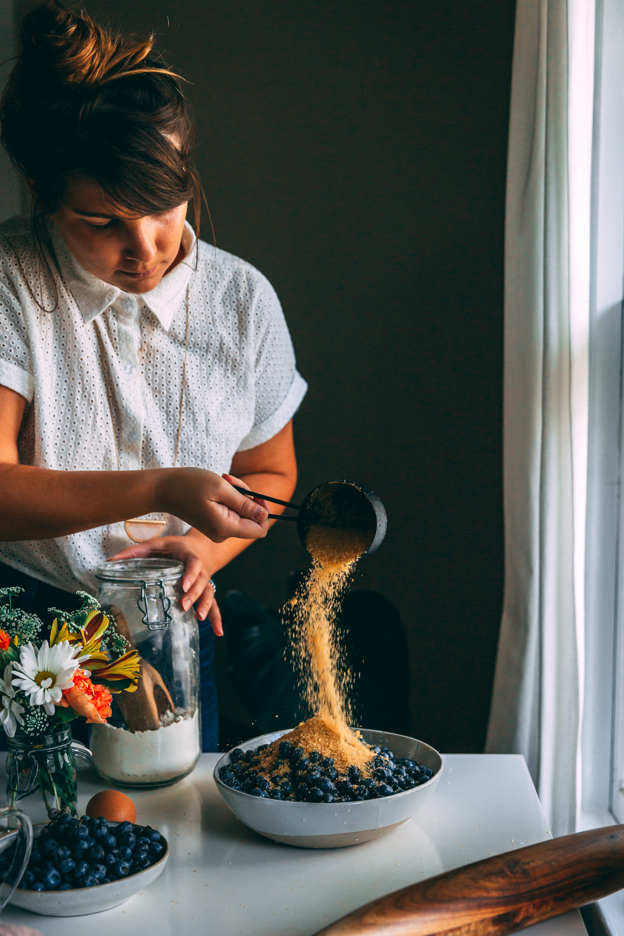 woman making easy blueberry pie filling 
