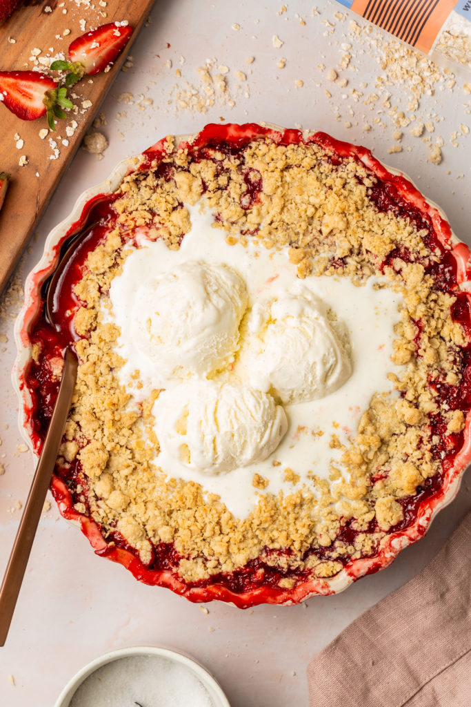 gluten free rhubarb crisp topped with scoops of vanilla ice cream