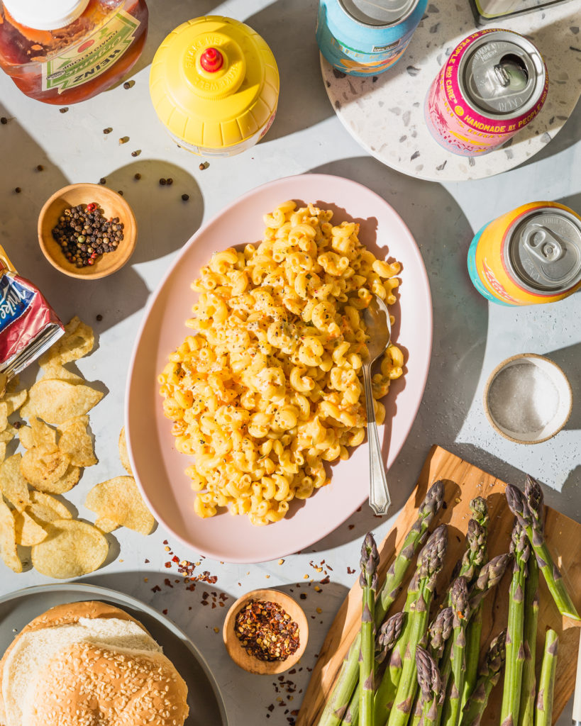 hawaiian mac salad on pink platter surrounded by cookout sides