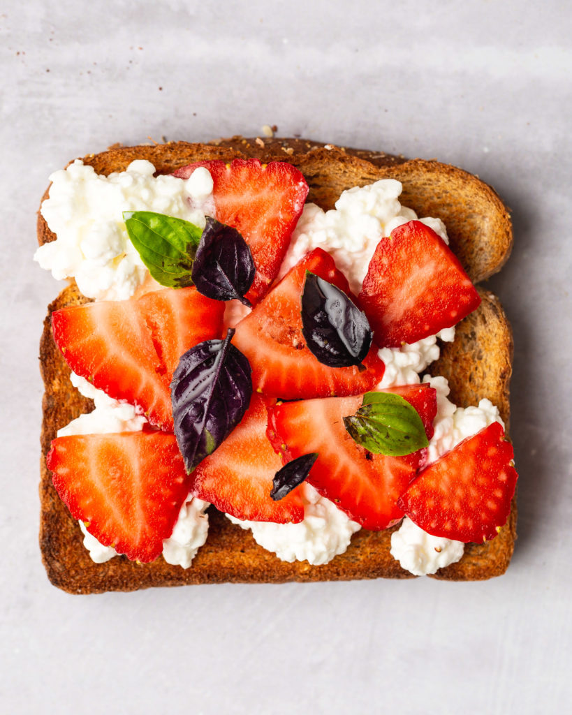 breakfast toast idea with cottage cheese, strawberries, and basil