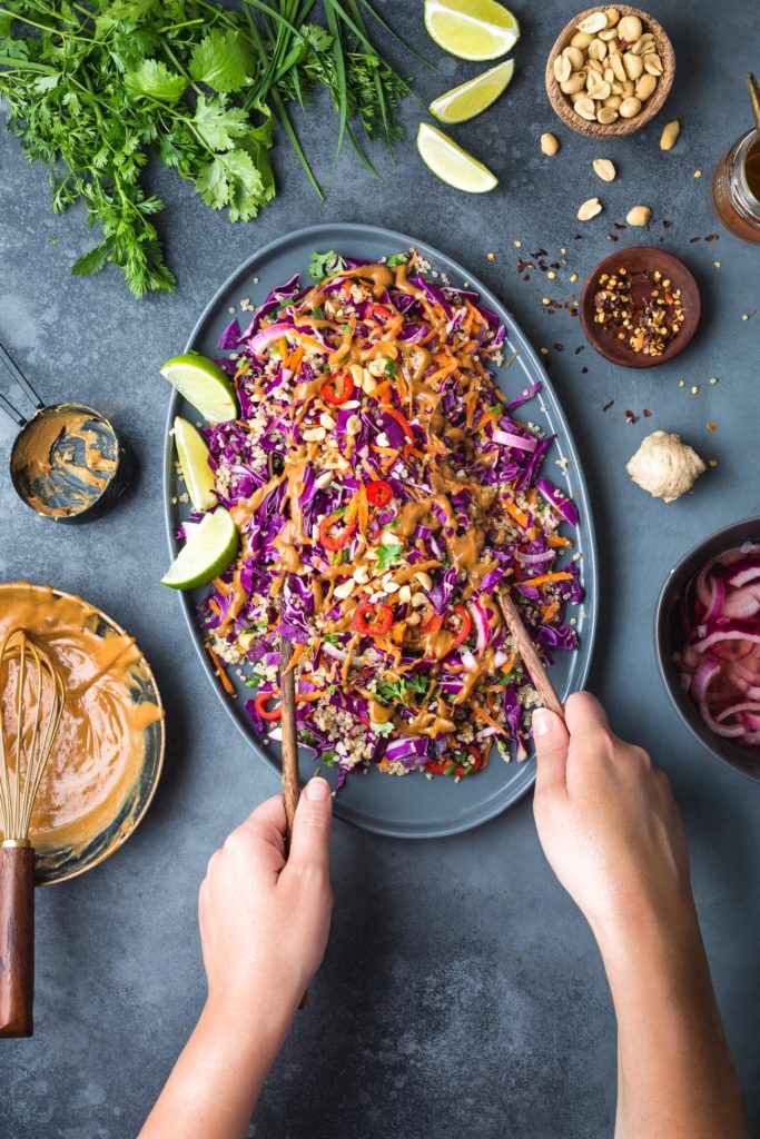 thai quinoa salad on serving platter with peanut dressing