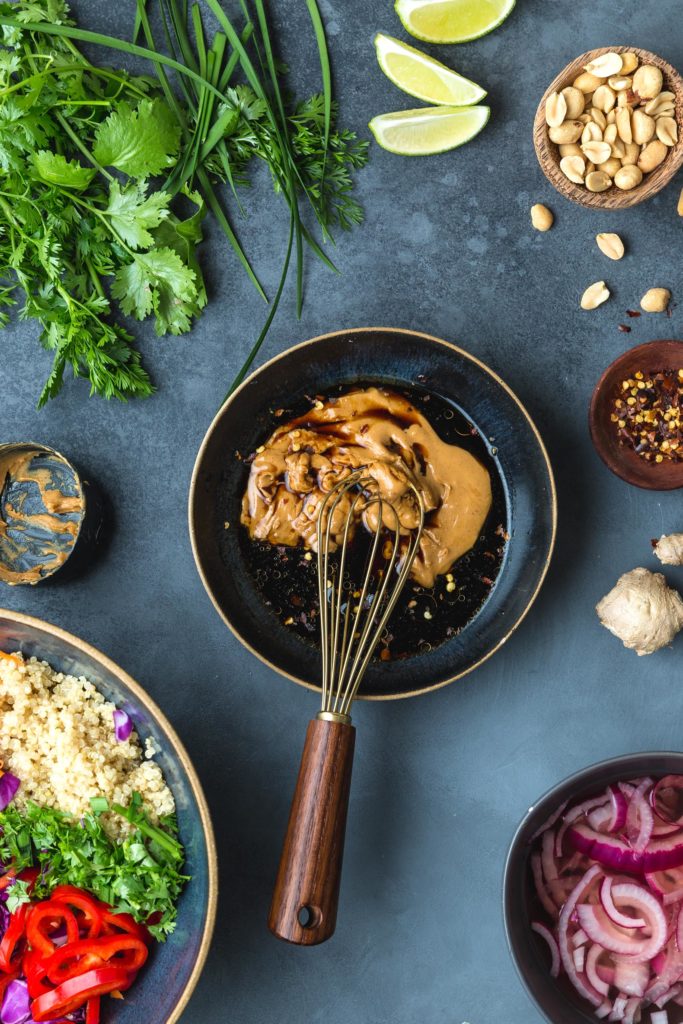 whisking together peanut ginger dressing
