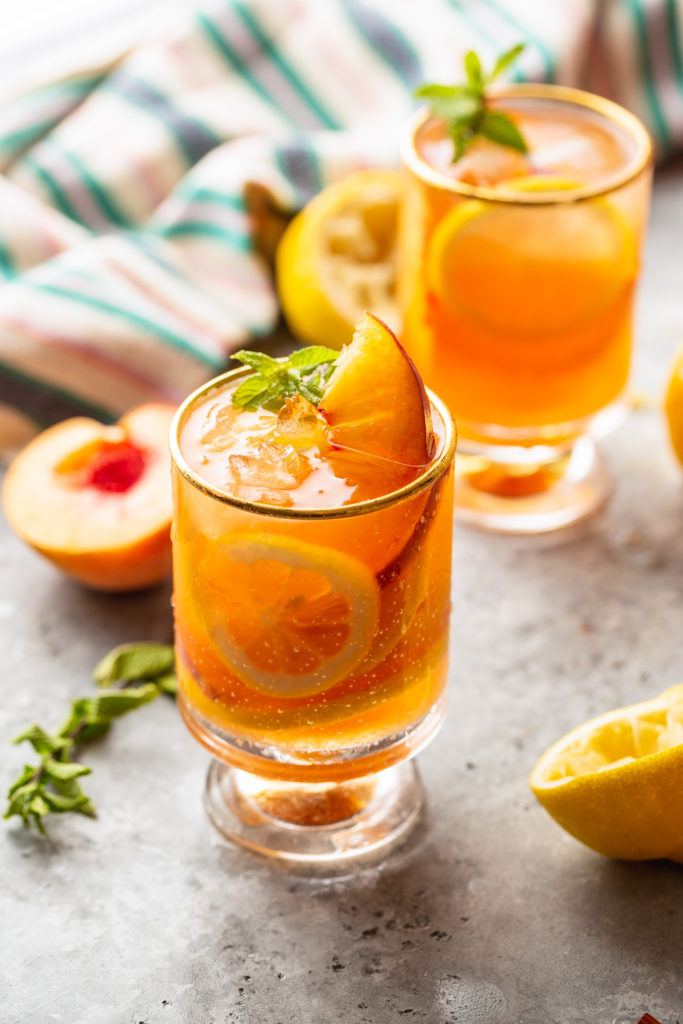 two glasses of peach iced tea and lemonade