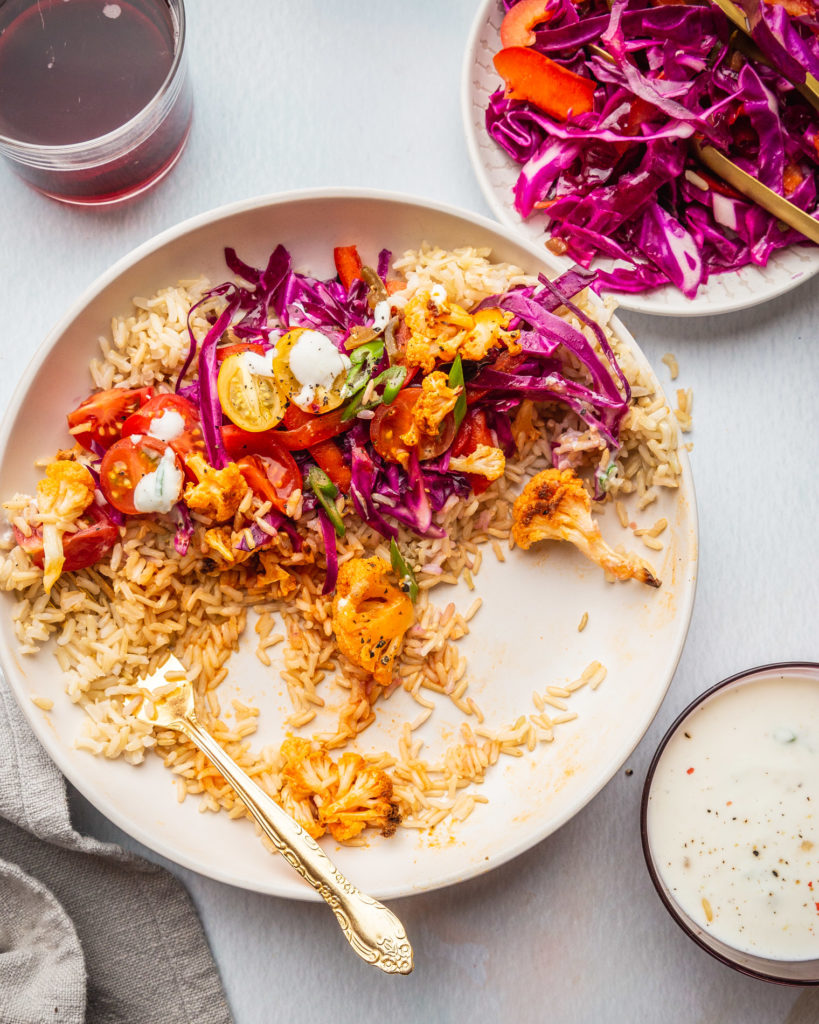 overhead view of partially eaten Buffalo Cauliflower Bowl