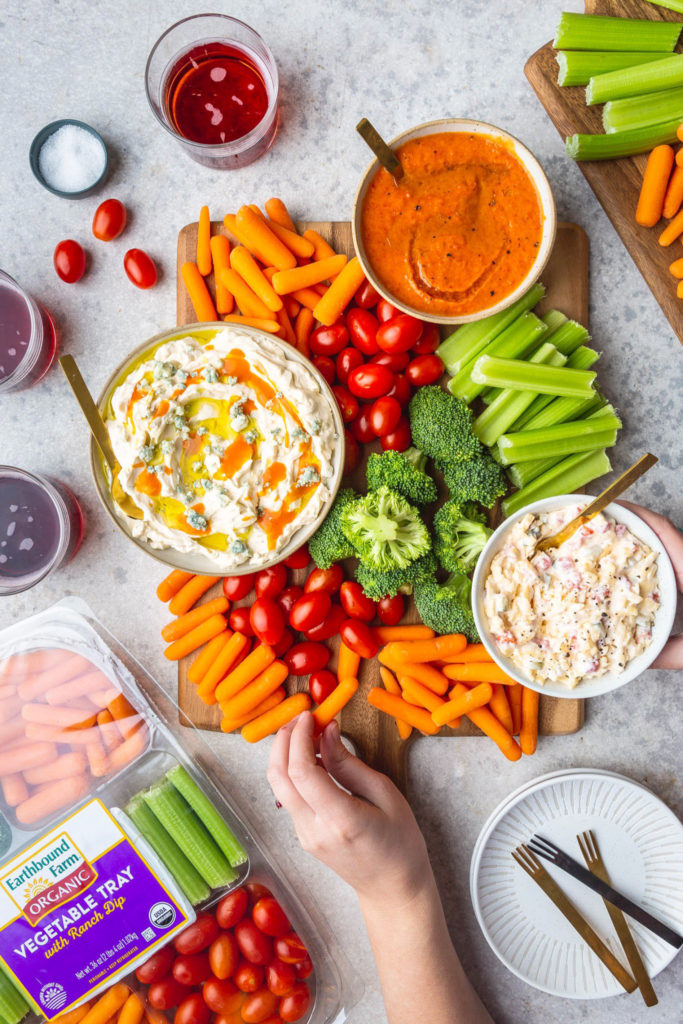 3 easy dips in bowls on wood board with veggies