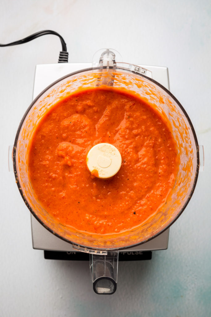 white bean romesco sauce in bowl of food processor 