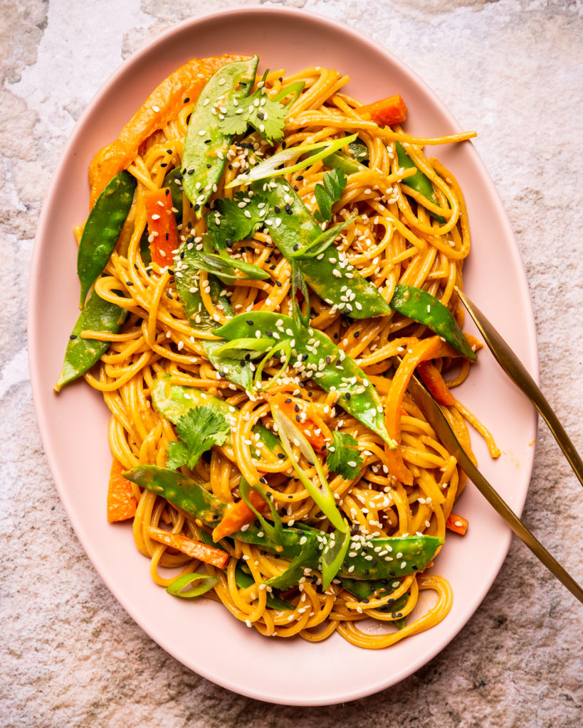 overhead view of Sesame Peanut Noodles on pink serving platter