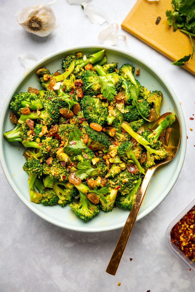 overhead view of Broccoli Raisin Salad on blue plate with spoon