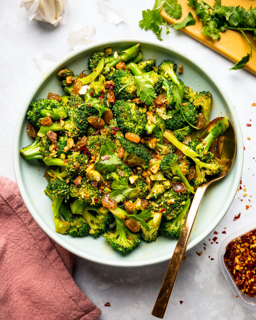 overhead view of Broccoli Raisin Salad on blue plate with spoon