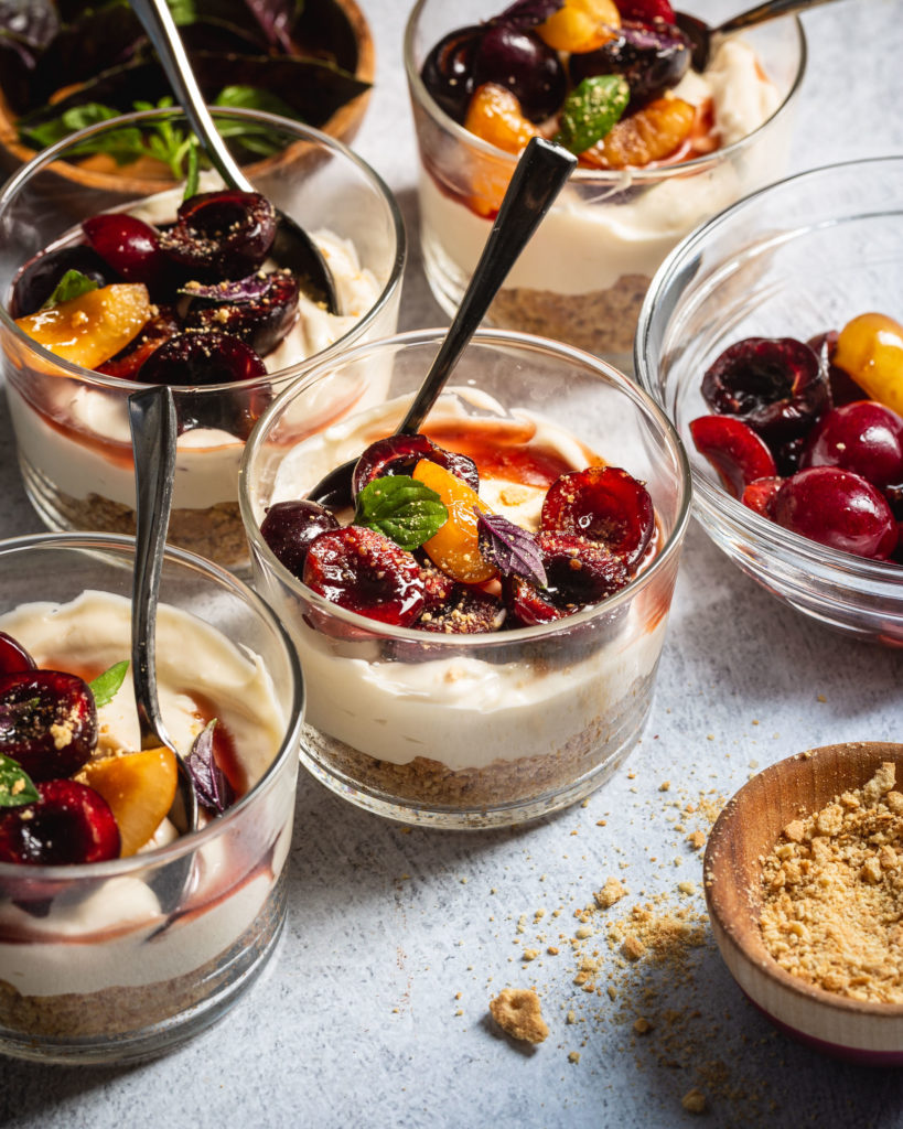 close up of cherries on top of cheesecake