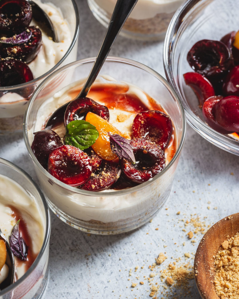 cherries and basil on top of cheesecake cups