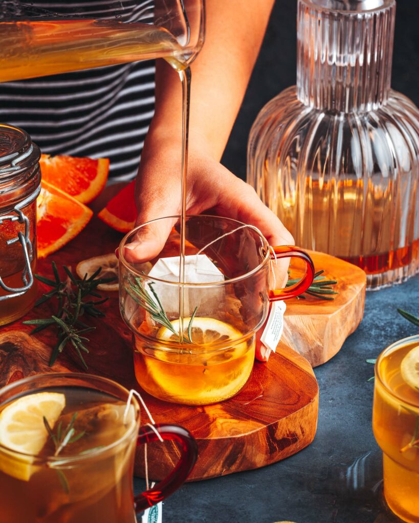 pouring simple syrup into the cocktail glass