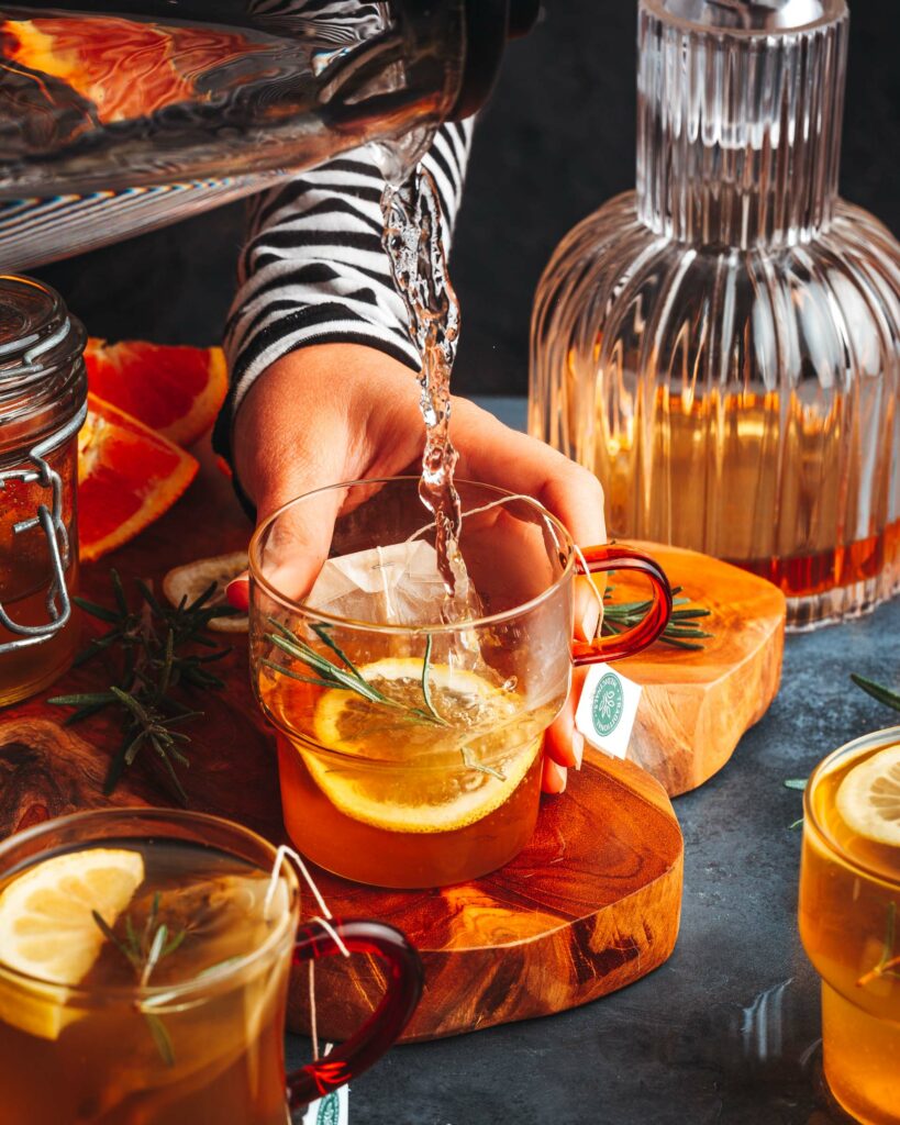 pouring hot water into the chamomile hot toddy cocktail glass