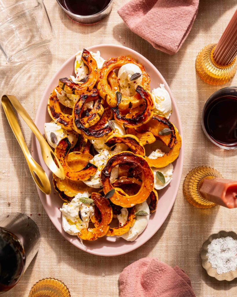 roasted delicata squash with burrata on table